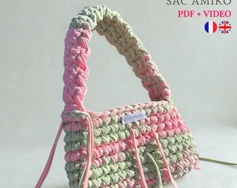 May include: A handmade crochet bag in shades of pink and green. The bag features a braided handle and a rectangular body with a label that reads "AMIKO". The text "PATRON SAC CROCHET" and "SAC AMIKO PDF + VIDEO" is visible at the top.