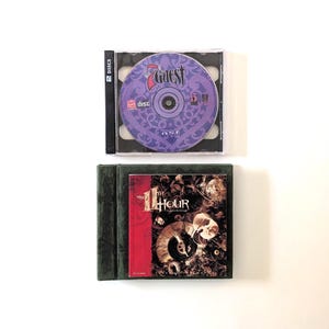 May include: A PC game set featuring a 2-disc jewel case for The 7th Guest with a purple patterned disc and a dark green box for The 11th Hour, which displays a red side panel and a detailed graphic cover with a clock and skull imagery.
