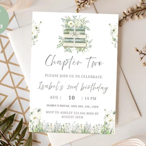May include: A white invitation card with the text "Chapter Two" and "Isabel's 2nd birthday". The card features floral and book illustrations. The text "editable in Canva" is in a green circle in the upper left corner.