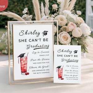 May include: A graduation party sign with the text "Shirley She Can't Be Graduating." The sign includes a cocktail illustration and instructions. A smaller version of the sign is also present. The signs are in a gold frame.