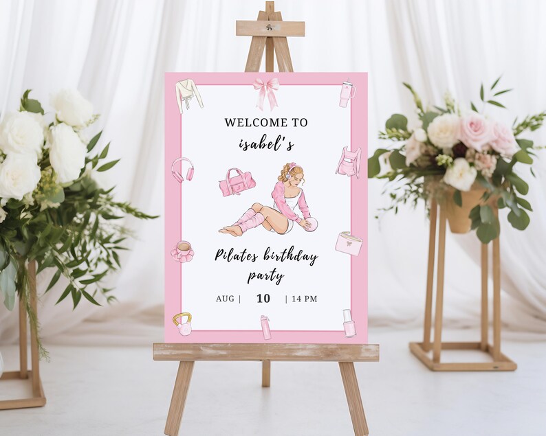 May include: A pink and white Pilates birthday party sign on a wooden easel. The sign features illustrations of workout gear and a woman in workout clothes. Text reads "Welcome to Isabel's Pilates birthday party" with the date and time.