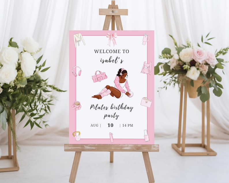 May include: A pink Pilates birthday party sign on a wooden easel. The sign features the text "Welcome to Isabel's" and "Pilates birthday party" with the date and time. The sign is decorated with illustrations of workout gear.