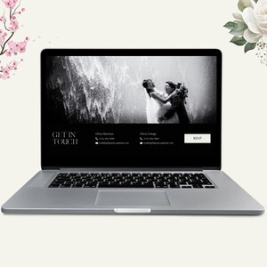 May include: A silver laptop displays a wedding website. The screen shows a black and white photo of a couple with a waterfall backdrop. Text on the screen reads "GET IN TOUCH" and contact information. A "RSVP" button is visible.