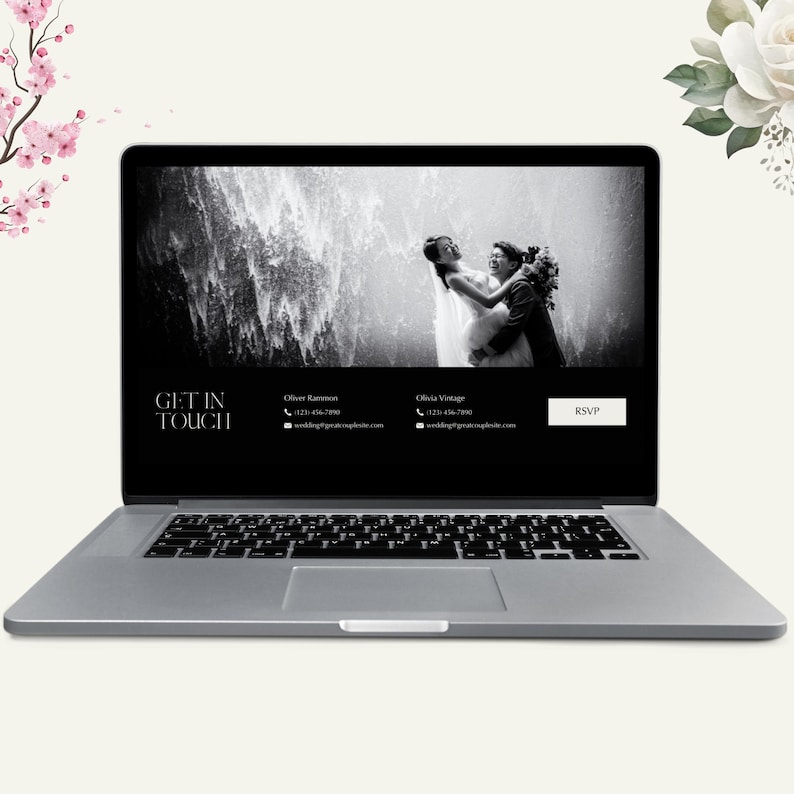 May include: A silver laptop displays a wedding website. The screen shows a black and white photo of a couple with a waterfall backdrop. Text on the screen reads "GET IN TOUCH" and contact information. A "RSVP" button is visible.