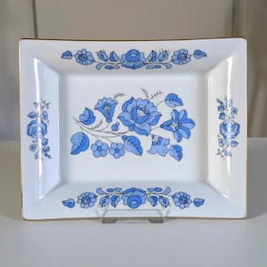 May include: A set of three ceramic mugs with a speckled, matte finish. The mugs are in shades of cream, light gray, and dark gray. Each mug has a simple, minimalist design, perfect for coffee or tea.