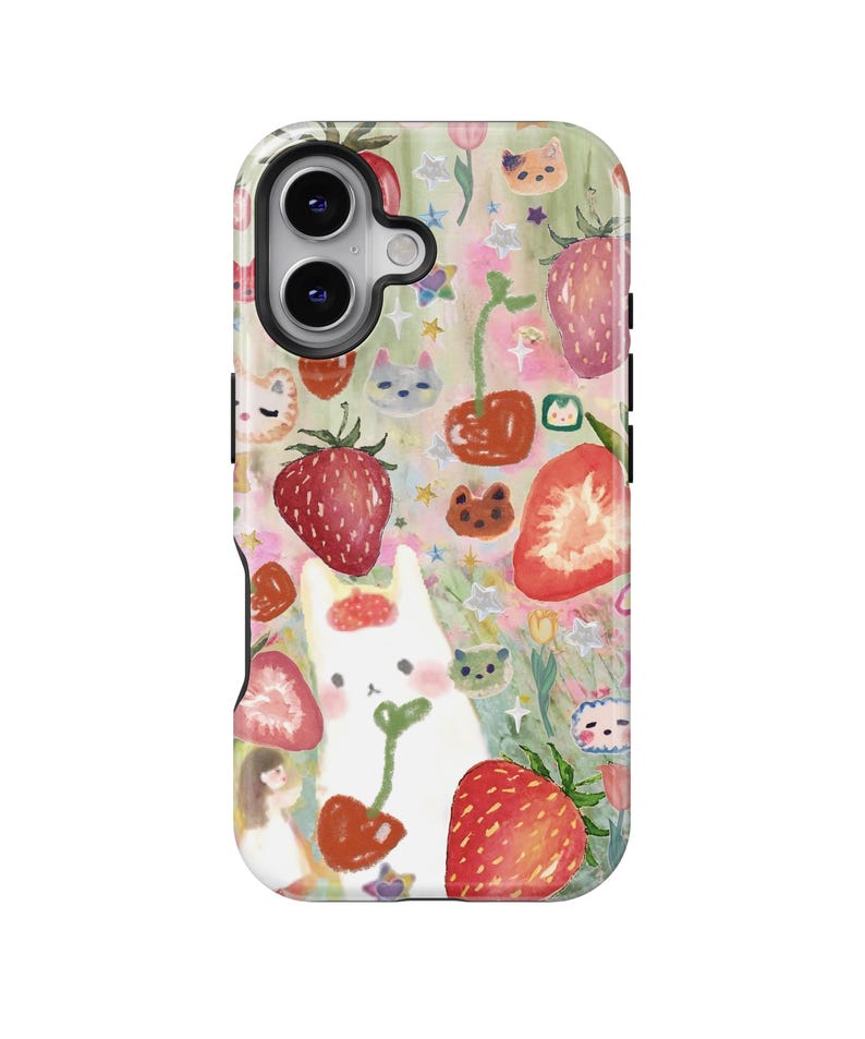 May include: A phone case featuring a whimsical design with strawberries, cherries, and a white cat. The case has a colorful pattern with cartoon-style illustrations of flowers, stars, and small animal faces. The case has a camera cutout.