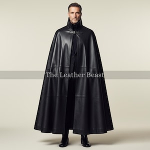 May include: A full-length black leather cape with a high collar and buckle closure. The cape is open in the front and reaches to the ankles. The text "The Leather Beast" is visible on the cape.