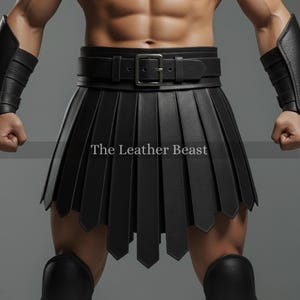 May include: Black leather kilt with a belt and buckle. The kilt has a pleated design with pointed edges at the hem. The text "The Leather Beast" is printed on the kilt.