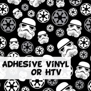 May include: Black background with a repeating pattern of white Stormtrooper helmets and Imperial symbols. The text "ADHESIVE VINYL OR HTV" is overlaid on the bottom of the image. This design is suitable for crafting projects.