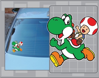 May include: A green Yoshi character sticker with a red saddle and orange shoes, carrying a Toad character with a white and red mushroom cap. The sticker is shown on a car window.