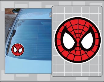 May include: A red, black, and white Spider-Man logo sticker. The sticker is round with a black border, a red spiderweb design, and white eye shapes. The sticker is shown on a car window.