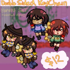 Może przedstawiać: Zestaw dwustronnych breloków do kluczy z postaciami z kreskówek. Breloki mają błyszczące wykończenie z żywicy epoksydowej i przedstawiają postacie z brązowymi i rudymi włosami, trzymające serca i kwiaty. Widoczny jest tekst "Humans Set".