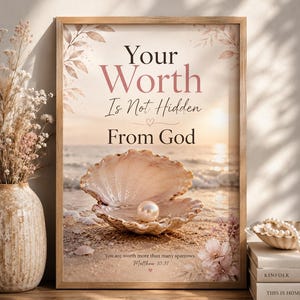 May include: A framed wall art print featuring a beach scene with an open seashell containing a pearl. The text reads: Your Worth Is Not Hidden From God, and You are worth more than many sparrows. Matthew 10:31. The design includes soft floral accents.