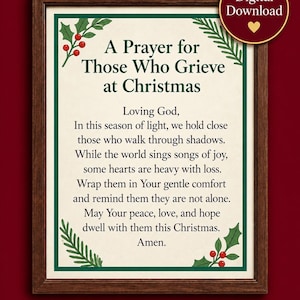 May include: A framed print featuring the text A Prayer for Those Who Grieve at Christmas, surrounded by a dark green border and decorated with holly leaves and red berries in the corners. The background is off-white with dark text.