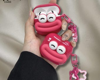 かわいい漫画の顔のイヤホンケース、大きな目が特徴のピンクのシリコン製AirPodsカバー、キーホルダーデザイン、彼女へのギフト