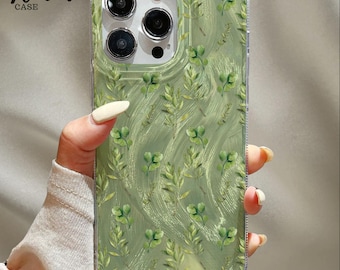 Könnte beinhalten: Transparente Handyhülle mit grünem botanischem Design mit Blättern und vierblättrigen Kleeblättern. Der Text "Venom Case" ist sichtbar. Entworfen für ein Smartphone.