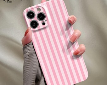 May include: A pink and white striped phone case with the text "Venom Case" in the upper left corner. The case has a camera cutout with three lenses. The case is held in a person's hand.