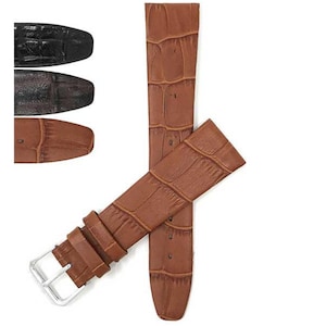 May include: A brown leather watch strap with a crocodile skin texture, featuring a silver buckle. The image also shows three additional watch straps in black, dark brown, and light brown.