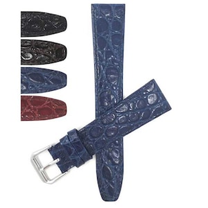 May include: A navy blue watch strap with a crocodile pattern and a silver buckle. The image also shows a selection of watch straps in black, brown, and burgundy.