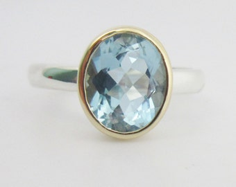 Sterling silver 14k yellow gold sky blue topaz ring bezel set