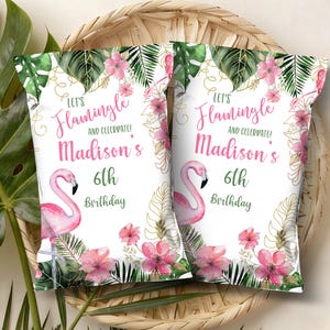 May include: Two rectangular snack bags featuring a white background with pink flamingo illustrations, green tropical leaves, and pink flowers. The text reads Let's Flamingle and celebrate! Madison's 6th Birthday in pink and green script and print fonts.