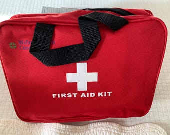 May include: Red first aid kit with a white cross and the text "FIRST AID KIT" printed on the front. The kit has a black zipper and two black handles.