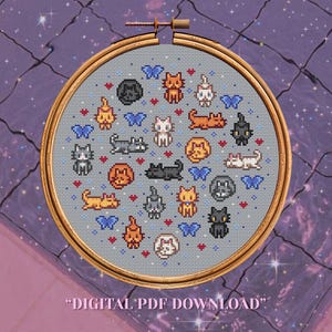 May include: A circular wooden embroidery hoop containing a cross-stitch pattern on light gray fabric. The design features various pixelated cats in orange, black, gray, and white, interspersed with blue butterflies and red hearts. Text reads DIGITAL PDF DOWNLOAD.