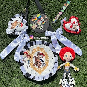 May include: A collection of Toy Story themed accessories including a round bag with a black and white cow print ruffle, a heart-shaped pin display, a plush Jessie doll, and various character pins. The bag features a gold frame graphic with Jessie and Bullseye. Text reads itsQueenV_.