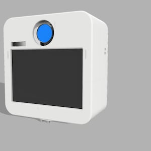 May include: A white, rectangular device with rounded corners, featuring a black screen and a blue circular element on top. The device has a small rectangular opening and is set against a gray background.