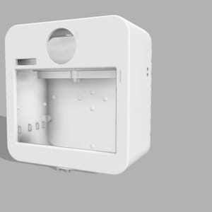 May include: A white, rectangular, open-faced device with rounded corners. It features a circular opening at the top, a rectangular slot, and several small circular indentations. The device is set against a gray background.