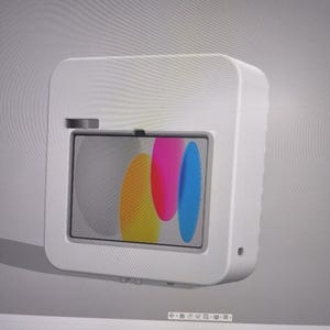 May include: A white, rectangular device with rounded edges, featuring a screen displaying colorful abstract shapes. The device has a small, dark-coloured button on top and a small hole on the side. The screen shows yellow, pink, and blue shapes.