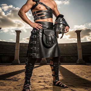 May include: A black leather gladiator costume, including a chest harness, skirt, and leg armor, is displayed. The outfit features multiple buckles and straps. A silver helmet is held in the right hand. The background shows a coliseum.