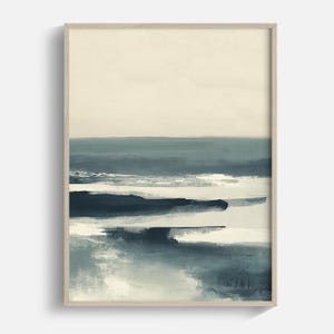 May include: Abstract landscape art print in a wooden frame. The artwork features a serene scene with layers of blue and white brushstrokes, evoking a sense of the sea and sky. The top portion is a soft beige, contrasting with the darker blues below.