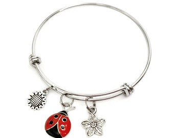 Ladybug and Flower themed bracelet. Gift for ladybug Lovers. Includes Ladybug and Two Flower Charms.