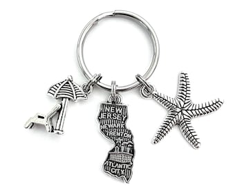 New Jersey themed keychain. Includes State of NJ, Beach Chair with Umbrella, and Starfish charms. Beach House Hostess Gift. Shore House.