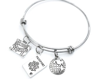 Travel themed bracelet. Includes Passport, World Globe, and International Suitcase.