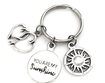 You are my Sunshine keychain. Gift for the Sunshine in your life. Bag + Key Identifier. Includes You are my Sunshine, Hearts, & Sun Charms.