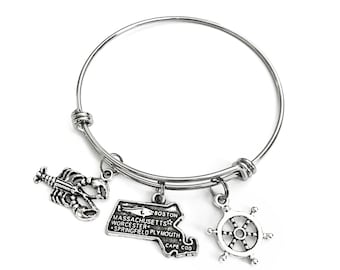 Massachusetts themed bracelet. Includes State of Massachusetts, a Lobster, and Ship Wheel Charms. Boston Lover Gift.