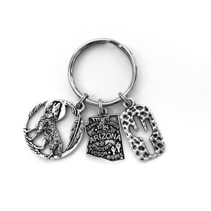 Arizona themed keychain. Includes State of Arizona, a Cactus, and Coyote charms. Phoenix, Tucson, Scottsdale, Grand Canyon Gift.