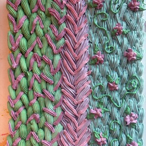 May include: A square artwork with a textured surface, divided into three sections. The left section has a green and pink woven pattern. The centre section has a pink braided design. The right section has a blue-green background with green vines and pink flowers.