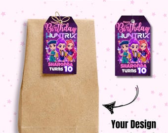 May include: A brown paper bag with a decorative tag attached. The tag features the text "Happy Birthday HUNTRIX" and "SHARONDA TURNS 10" with cartoon characters. The words "THANKYOU TAG" are at the top. The image also includes the text "Your Design Look Like This!"