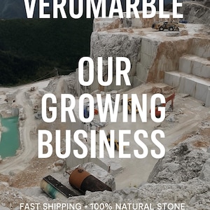 May include: An aerial view of a marble quarry with the text "VEROMARBLE OUR GROWING BUSINESS" in white. The image shows heavy machinery, cut marble blocks, and a turquoise-colored pool of water.