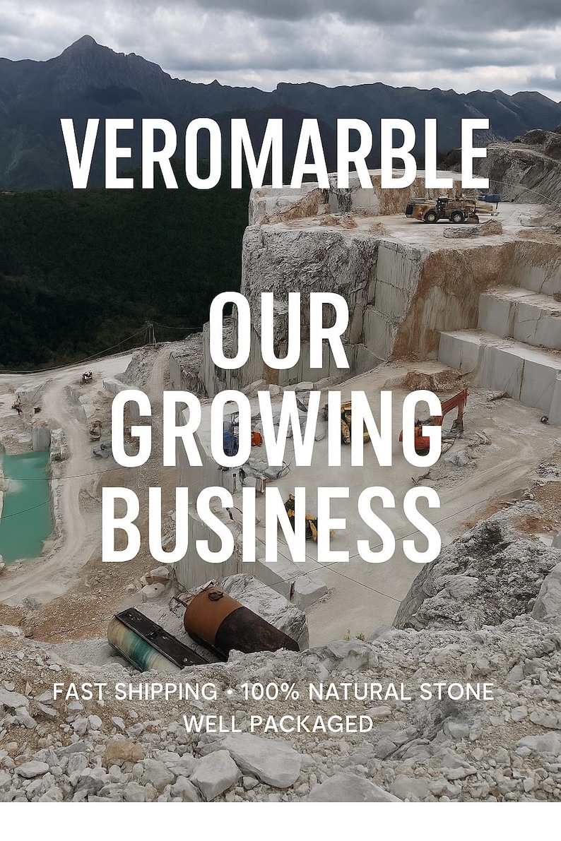 May include: An aerial view of a marble quarry with the text "VEROMARBLE OUR GROWING BUSINESS" in white. The image shows heavy machinery, cut marble blocks, and a turquoise-colored pool of water.