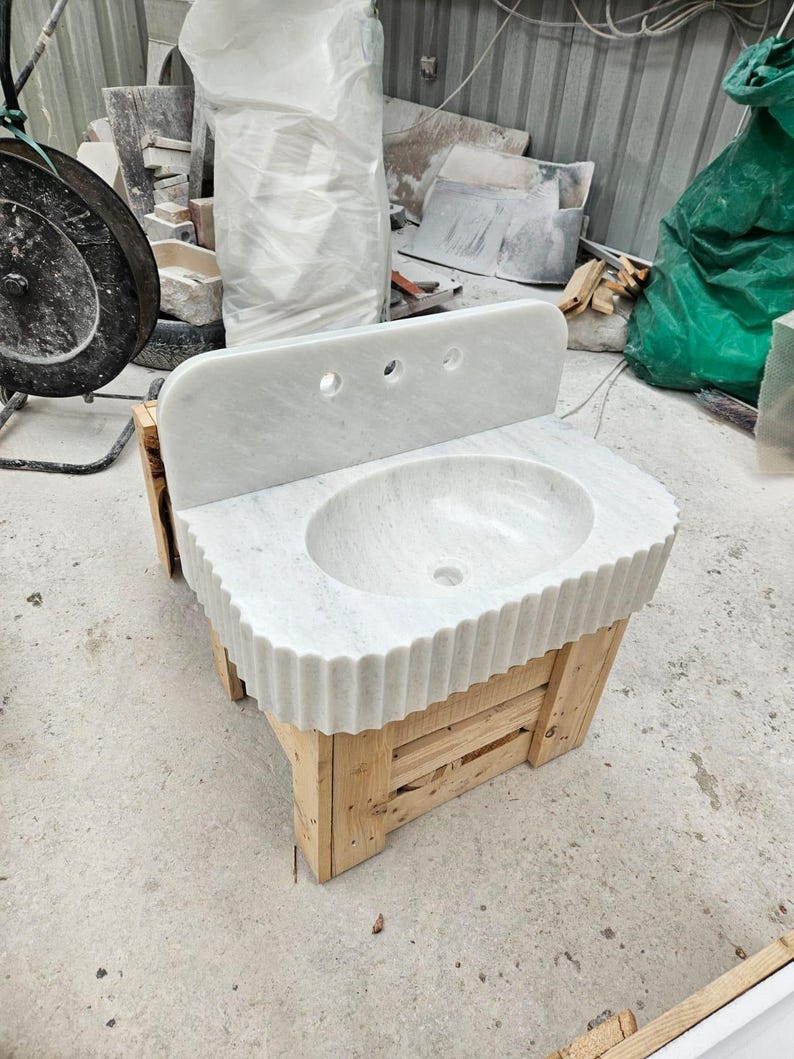 May include: A set of three ceramic mugs with a speckled, matte finish. The mugs are in shades of cream, light gray, and dark gray. Each mug has a simple, minimalist design, perfect for coffee or tea.