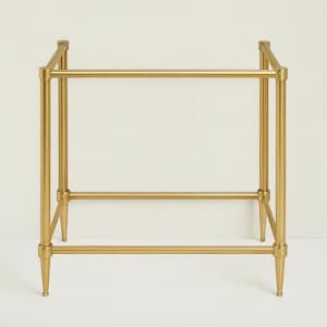 Puede incluir: Estructura de mesa auxiliar de metal dorado. El marco tiene forma rectangular con cuatro patas y barras horizontales de soporte. Las patas tienen un diseño cónico y el estilo general es moderno.