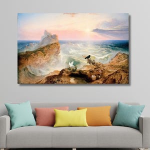May include: A framed canvas print of a seascape painting. The artwork depicts a dramatic scene with crashing waves, rocky cliffs, and a vibrant sunset. Two birds are perched on the rocks. The color palette includes blues, browns, and oranges.