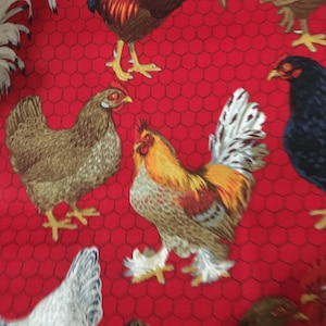 May include: Red fabric with a chicken coop pattern. The fabric features a repeating pattern of roosters and hens in various poses. The background is a red chicken wire pattern.