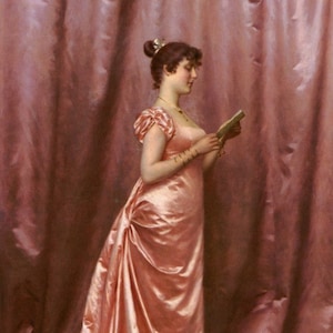 May include: A woman in a pink satin gown stands in front of a pink curtain, reading a letter. She is wearing a pearl necklace and bracelets.