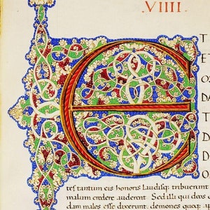 May include: A brightly colored illuminated manuscript page with a large capital letter "E" in gold, red, green, and blue. The letter is decorated with intricate floral patterns and swirls. The text on the page is in Latin.