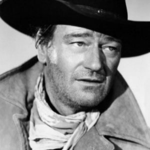 May include: A black and white photo of a man wearing a cowboy hat and a leather jacket. He is looking off to the side and has a serious expression on his face.
